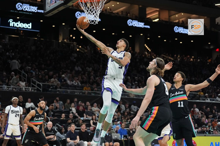 Feb 21, 2026; Austin, Texas, USA;  Sacramento Kings guard Nique Clifford (5) shoots in front of San Antonio Spurs forwards Kelly Olynyk (8) and Carter Bryant (11) in the second half at Moody Center. Credit: Daniel Dunn-Imagn Images