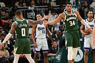 Jan 14, 2025; Milwaukee, Wisconsin, USA; Milwaukee Bucks forward Giannis Antetokounmpo (34) reacts with guard Damian Lillard (0) after scoring a basket in the second quarter against the Sacramento Kings at Fiserv Forum. Mandatory Credit: Benny Sieu-Imagn Images