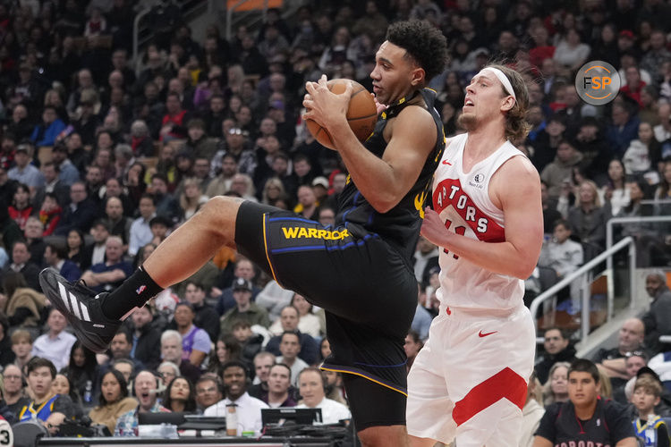 Jan 13, 2025; Toronto, Ontario, CAN; Golden State Warriors forward Trayce Jackson-Davis (32) collects a rebound against Toronto Raptors forward Kelly Olynyk (41) during the first half at Scotiabank Arena. Credit: John E. Sokolowski-Imagn Images