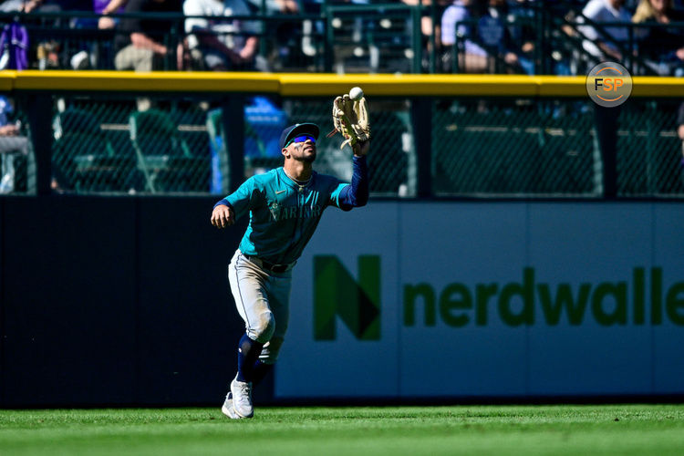 DENVER, CO - APRIL 21: Seattle Mariners outfielder Jonatan Clase (5) catches a fly ball in the eighth inning during a game between the Seattle Mariners and the Colorado Rockies at Coors Field on April 21, 2024 in Denver, Colorado. (Photo by Dustin Bradford/Icon Sportswire)