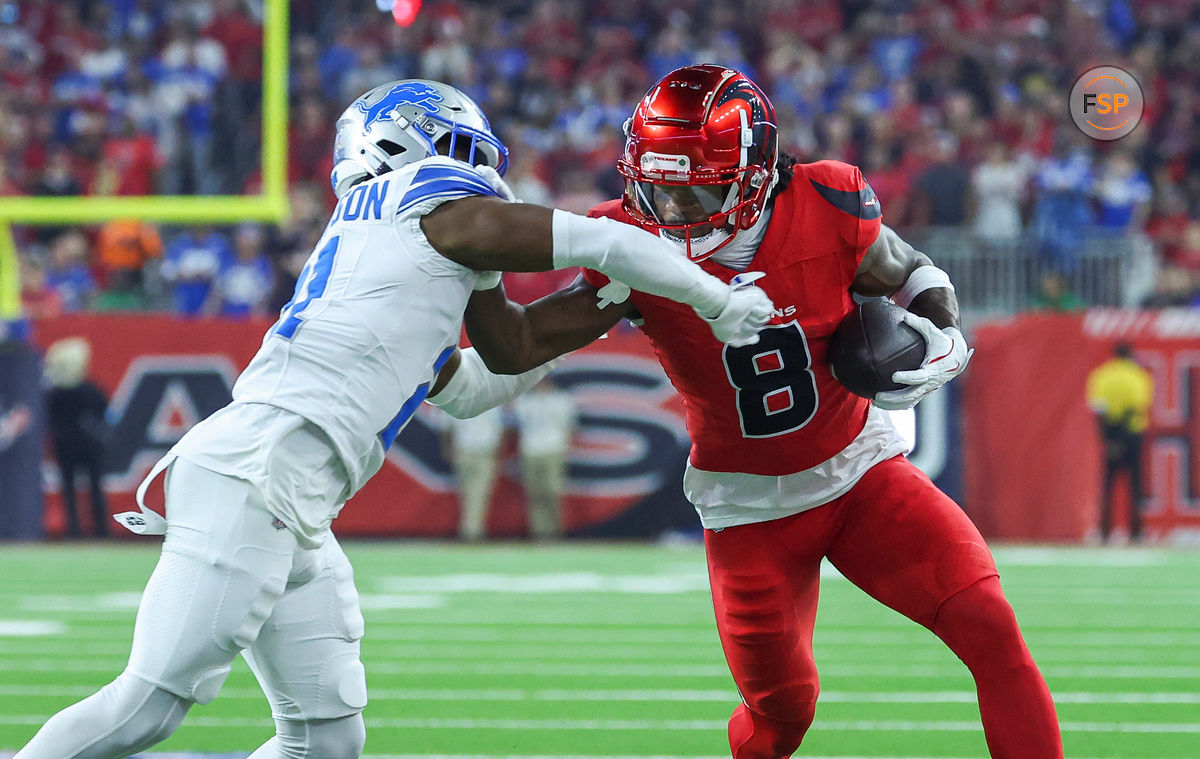 Nov 10, 2024; Houston, Texas, USA; Houston Texans wide receiver John Metchie III (8) makes a reception as Detroit Lions cornerback Amik Robertson (21) defends during the first quarter at NRG Stadium. Credit: Troy Taormina-Imagn Images