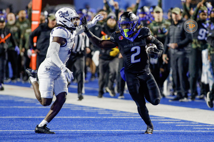 Nov 9, 2024; Boise, Idaho, USA; Boise State Broncos running back Ashton Jeanty (2) runs the ball against Nevada Wolf Pack safety Kitan Crawford (4) during the first quarter at Albertsons Stadium. Credit: Brian Losness-Imagn Images