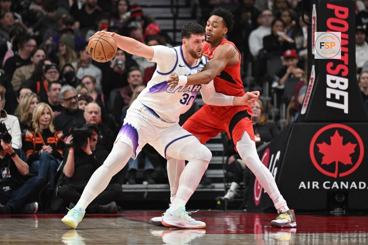Feb 1, 2026; Toronto, Ontario, CAN;  Utah Jazz center Jusuf Nurkic (30) holds the ball away from Toronto Raptors forward Scottie Barnes (4) in the first half at Scotiabank Arena. Credit: Dan Hamilton-Imagn Images