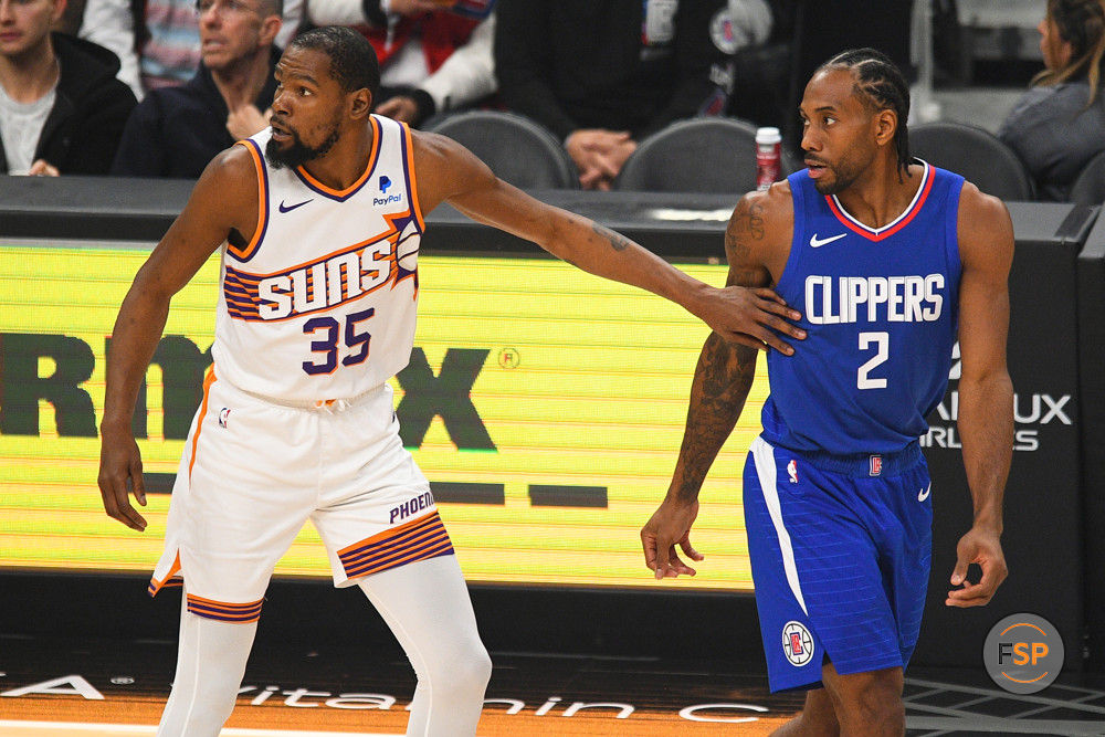 LOS ANGELES, CA - JANUARY 08: Phoenix Suns Forward Kevin Durant (35) and Los Angeles Clippers Forward Kawhi Leonard (2) look on during a NBA game between the Phoenix Suns and the Los Angeles Clippers on January 8, 2023 at Crypto.com Arena in Los Angeles, CA. (Photo by Brian Rothmuller/Icon Sportswire)