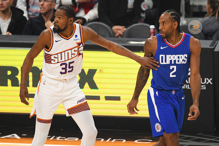 LOS ANGELES, CA - JANUARY 08: Phoenix Suns Forward Kevin Durant (35) and Los Angeles Clippers Forward Kawhi Leonard (2) look on during a NBA game between the Phoenix Suns and the Los Angeles Clippers on January 8, 2023 at Crypto.com Arena in Los Angeles, CA. (Photo by Brian Rothmuller/Icon Sportswire)