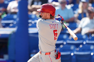 Feb 26, 2025; Dunedin, Florida, USA; Philadelphia Phillies second base Bryson Stott (5) hits an rbi single against the Toronto Blue Jays in the sixth inning during spring training at TD Ballpark. Mandatory Credit: Nathan Ray Seebeck-Imagn Images