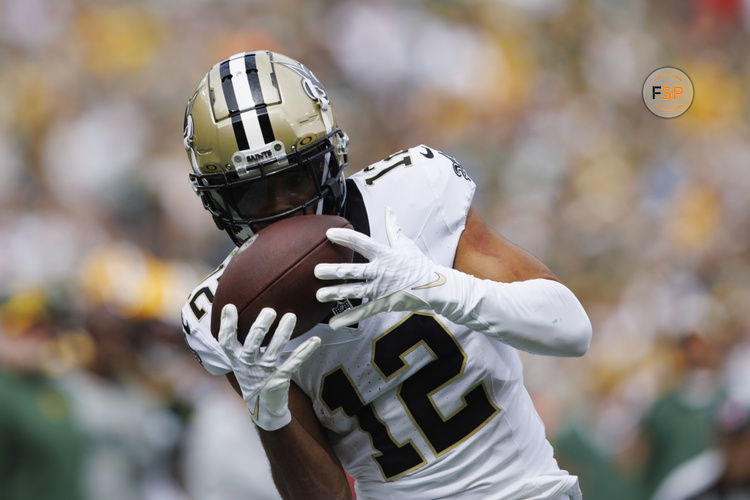 Sep 24, 2023; Green Bay, Wisconsin, USA;  New Orleans Saints wide receiver Chris Olave (12) catches a pass during the second quarter against the Green Bay Packers at Lambeau Field. Credit: Jeff Hanisch-USA TODAY Sports