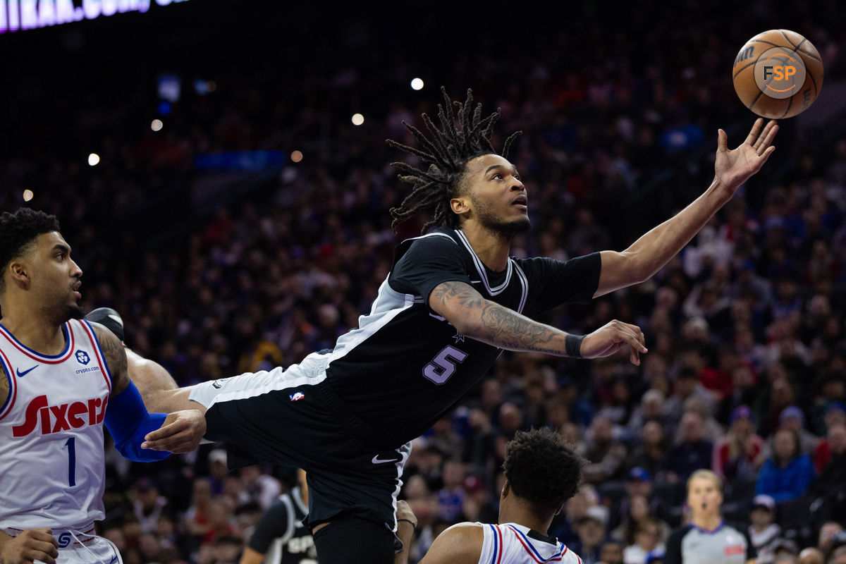 Dec 23, 2024; Philadelphia, Pennsylvania, USA; San Antonio Spurs guard Stephon Castle (5) commits an offensive foul while driving for a shot against the Philadelphia 76ers during the third quarter at Wells Fargo Center. Credit: Bill Streicher-Imagn Images