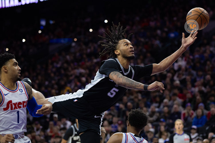 Dec 23, 2024; Philadelphia, Pennsylvania, USA; San Antonio Spurs guard Stephon Castle (5) commits an offensive foul while driving for a shot against the Philadelphia 76ers during the third quarter at Wells Fargo Center. Credit: Bill Streicher-Imagn Images