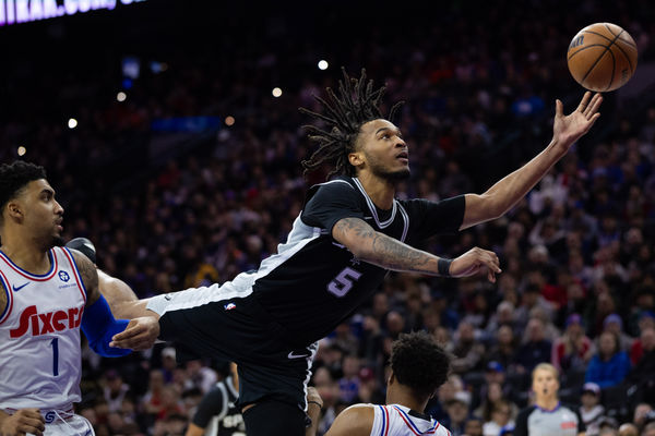 Dec 23, 2024; Philadelphia, Pennsylvania, USA; San Antonio Spurs guard Stephon Castle (5) commits an offensive foul while driving for a shot against the Philadelphia 76ers during the third quarter at Wells Fargo Center. Mandatory Credit: Bill Streicher-Imagn Images