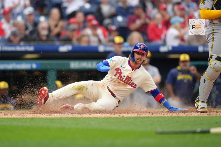 May 31, 2025; Philadelphia, Pennsylvania, USA; Philadelphia Phillies infielder Bryson Stott (5) slides home to score against the Milwaukee Brewers in the sixth inning at Citizens Bank Park. Credit: Kyle Ross-Imagn Images