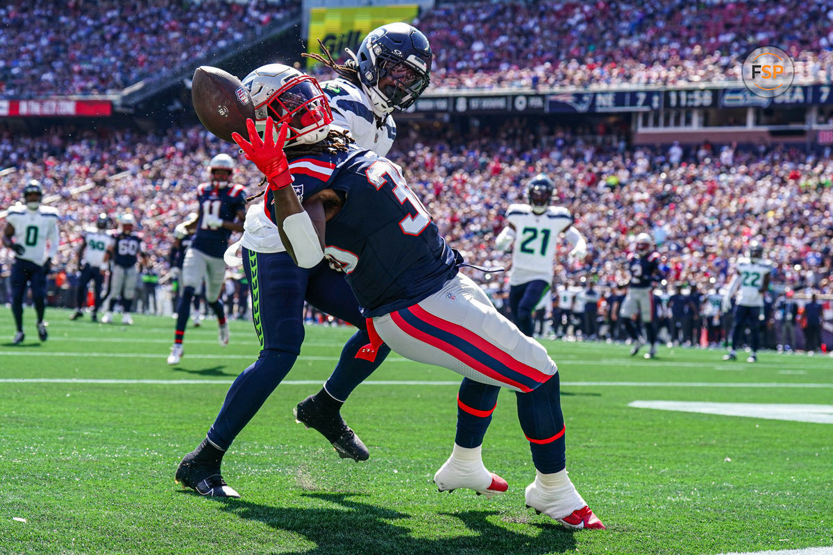 Sep 15, 2024; Foxborough, Massachusetts, USA; New England Patriots running back Rhamondre Stevenson (38) misses the pass against Seattle Seahawks linebacker Jerome Baker (17) in the second quarter at Gillette Stadium. Credit: David Butler II-Imagn Images