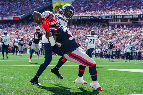 Sep 15, 2024; Foxborough, Massachusetts, USA; New England Patriots running back Rhamondre Stevenson (38) misses the pass against Seattle Seahawks linebacker Jerome Baker (17) in the second quarter at Gillette Stadium. Mandatory Credit: David Butler II-Imagn Images