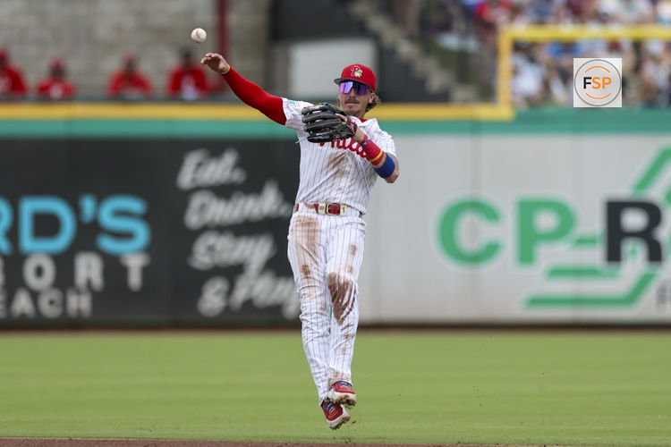 Mar 15, 2026; Clearwater, Florida, USA; Philadelphia Phillies second baseman Bryson Stott (5) trows to first for an out against the Atlanta Braves in the third inning during spring training at BayCare Ballpark. Credit: Nathan Ray Seebeck-Imagn Images