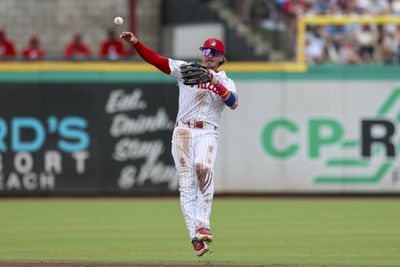 Mar 15, 2026; Clearwater, Florida, USA; Philadelphia Phillies second baseman Bryson Stott (5) trows to first for an out against the Atlanta Braves in the third inning during spring training at BayCare Ballpark. Mandatory Credit: Nathan Ray Seebeck-Imagn Images