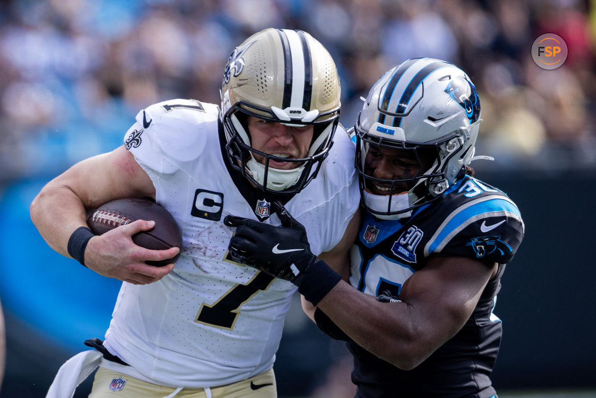 Nov 3, 2024; Charlotte, North Carolina, USA; New Orleans Saints tight end Taysom Hill (7) is hit by Carolina Panthers safety Demani Richardson (36) during the first quarter at Bank of America Stadium. Credit: Scott Kinser-Imagn Images