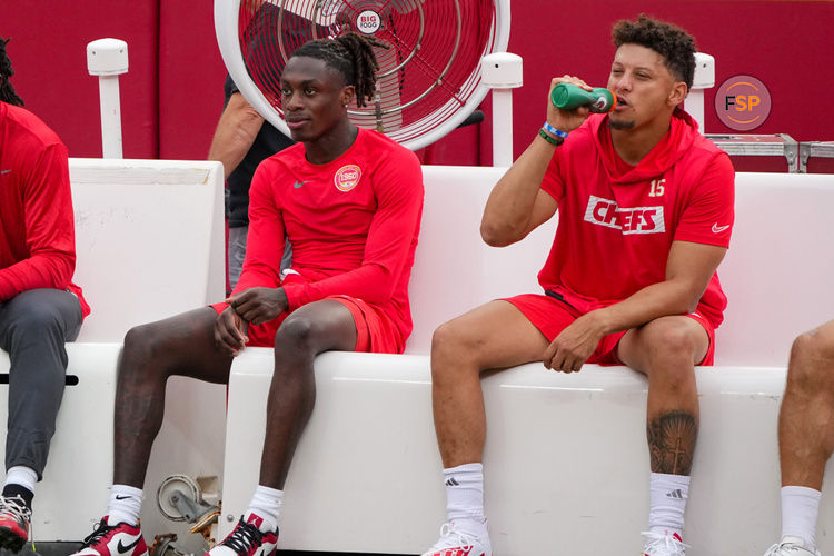 Aug 22, 2024; Kansas City, Missouri, USA; Kansas City Chiefs wide receiver Xavier Worthy (1) and quarterback Patrick Mahomes (15) sit on their bench during warm ups against the Chicago Bears prior to a game at GEHA Field at Arrowhead Stadium. Credit: Denny Medley-USA TODAY Sports