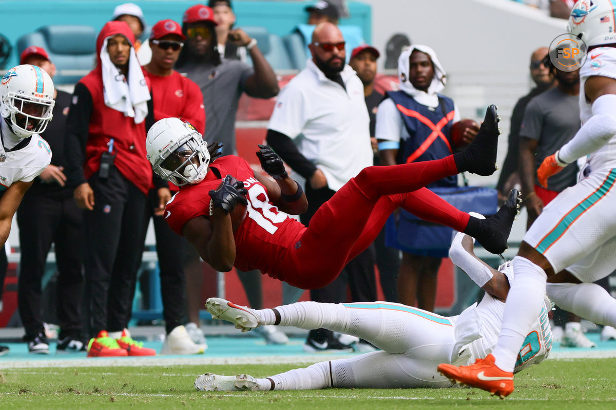 Oct 27, 2024; Miami Gardens, Florida, USA; Arizona Cardinals wide receiver Marvin Harrison Jr. (18) makes a catch against Miami Dolphins safety Jevon Holland (8) during the first quarter at Hard Rock Stadium. Credit: Sam Navarro-Imagn Images