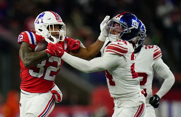 Dec 1, 2025; Foxborough, Massachusetts, USA; New England Patriots running back TreVeyon Henderson (32) runs the ball against New York Giants safety Dane Belton (24) during the fourth quarter at Gillette Stadium. Mandatory Credit: David Butler II-Imagn Images