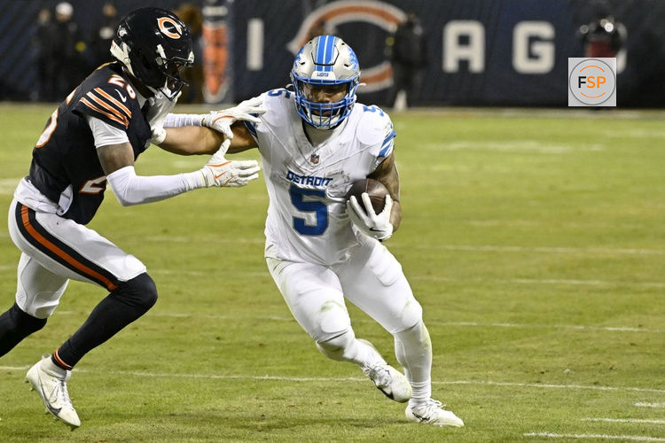 Jan 4, 2026; Chicago, Illinois, USA; Detroit Lions running back David Montgomery (5) runs with the ball against Chicago Bears cornerback Nahshon Wright (26) during the second half at Soldier Field. Credit: Matt Marton-Imagn Images