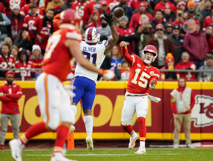 Dec 10, 2023; Kansas City, Missouri, USA; Kansas City Chiefs quarterback Patrick Mahomes (15) throws a pass to tight end Travis Kelce (87) as Buffalo Bills defensive tackle Ed Oliver (91) defends during the first half at GEHA Field at Arrowhead Stadium. Credit: Jay Biggerstaff-USA TODAY Sports