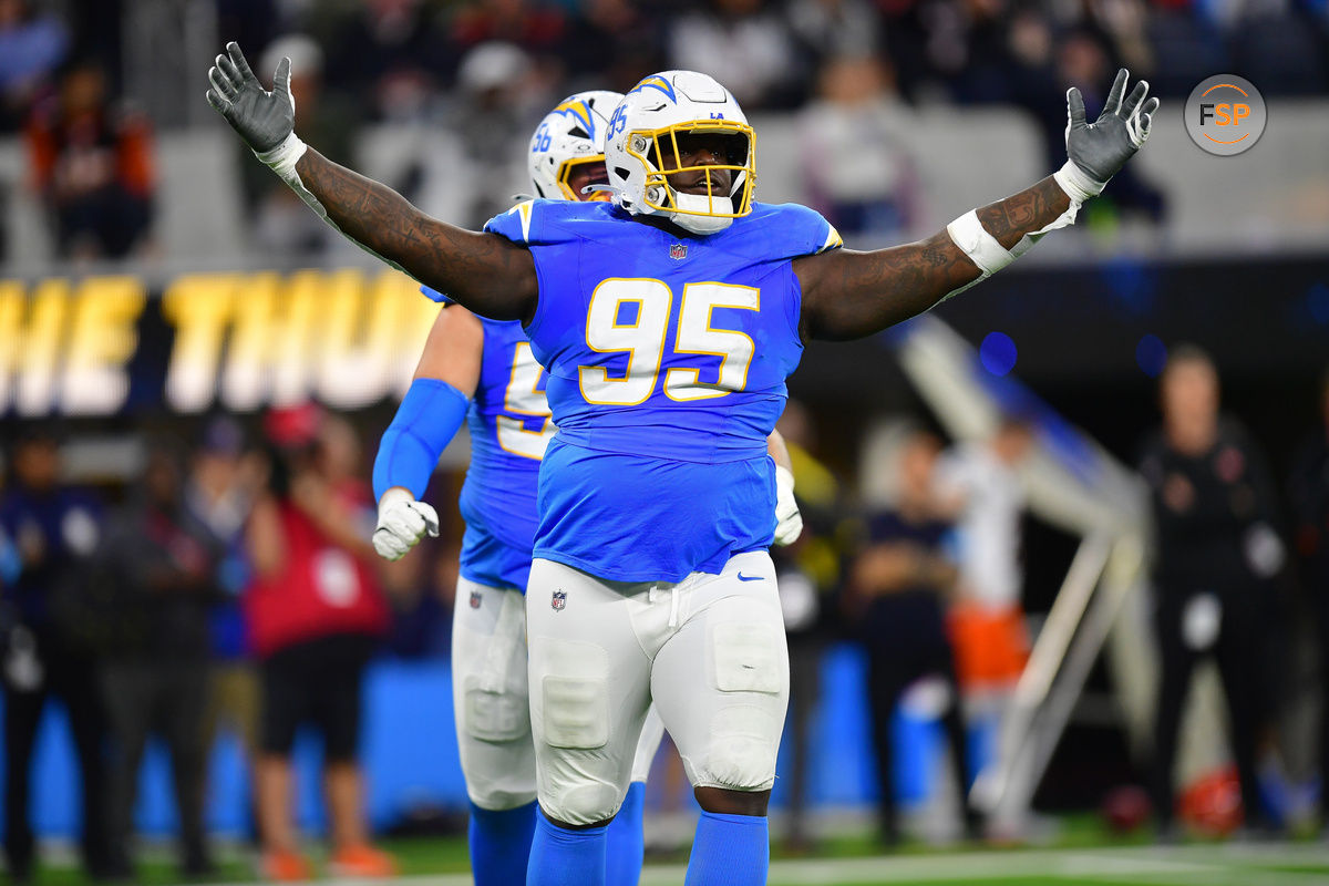 Nov 17, 2024; Inglewood, California, USA; Los Angeles Chargers defensive tackle Poona Ford (95) reacts after sacking Cincinnati Bengals quarterback Joe Burrow (9) during the first half at SoFi Stadium. Credit: Gary A. Vasquez-Imagn Images