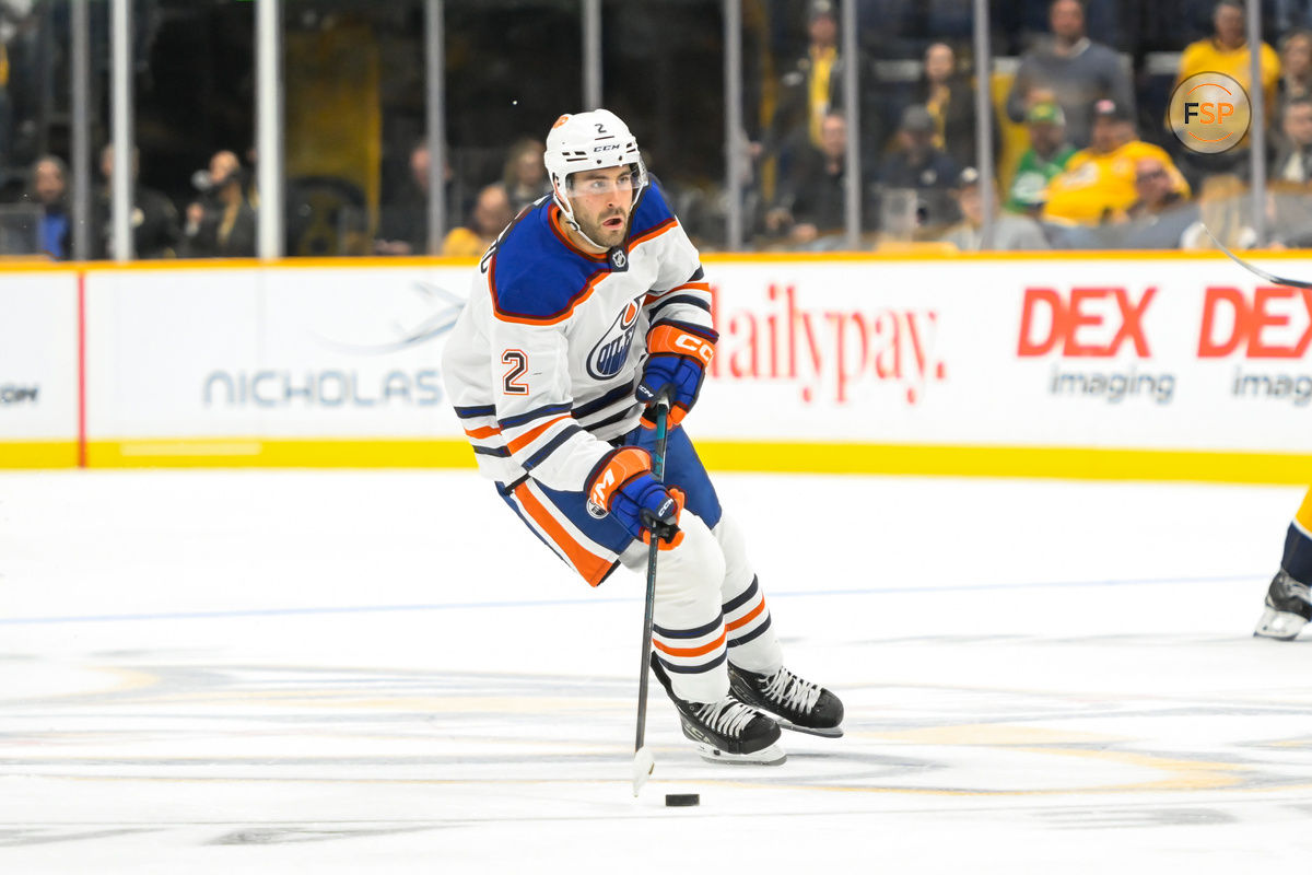 Oct 17, 2024; Nashville, Tennessee, USA;  Edmonton Oilers defenseman Evan Bouchard (2) skates with the puck against the Nashville Predators during the second period at Bridgestone Arena. Credit: Steve Roberts-Imagn Images