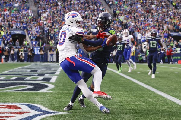Oct 27, 2024; Seattle, Washington, USA; Seattle Seahawks cornerback Riq Woolen (27) breaks up a potential touchdown pass to Buffalo Bills wide receiver Keon Coleman (0) during the first quarter at Lumen Field. Mandatory Credit: Joe Nicholson-Imagn Images
