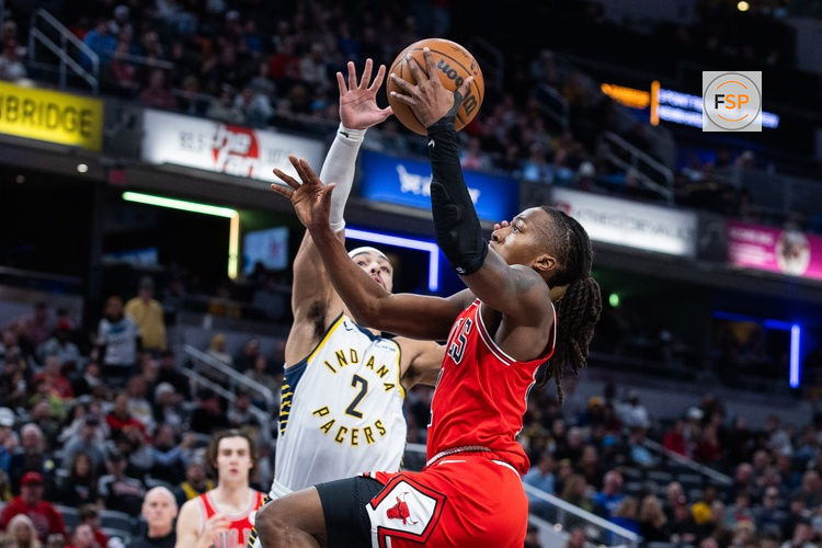 Jan 28, 2026; Indianapolis, Indiana, USA;  Chicago Bulls guard Ayo Dosunmu (11) shoots the ball while Indiana Pacers guard/forward Andrew Nembhard (2) defends in the first half at Gainbridge Fieldhouse. Credit: Trevor Ruszkowski-Imagn Images