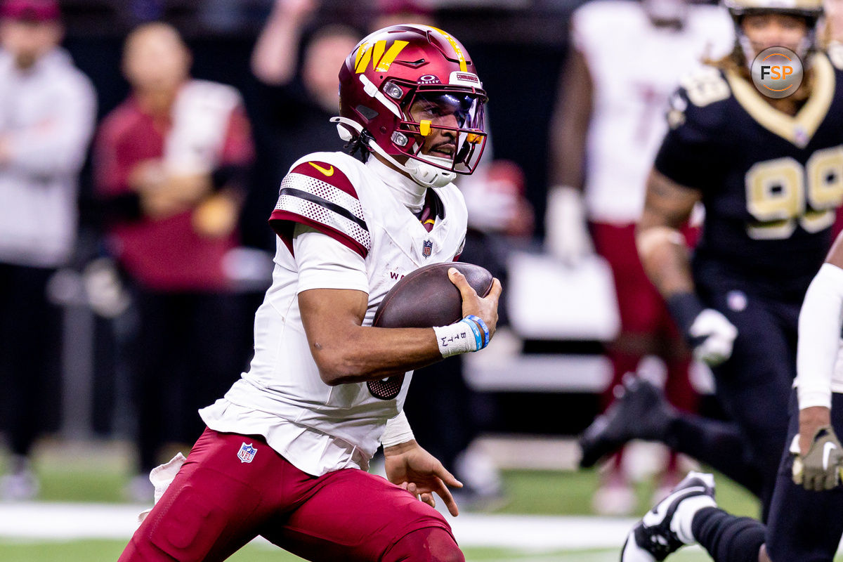 Dec 15, 2024; New Orleans, Louisiana, USA;  Washington Commanders quarterback Jayden Daniels (5) scrambles against the New Orleans Saints during the second half at Caesars Superdome. Credit: Stephen Lew-Imagn Images