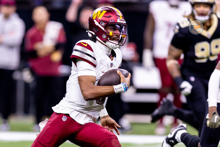 Dec 15, 2024; New Orleans, Louisiana, USA;  Washington Commanders quarterback Jayden Daniels (5) scrambles against the New Orleans Saints during the second half at Caesars Superdome. Credit: Stephen Lew-Imagn Images