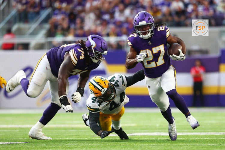 Sep 13, 2026; Minneapolis, Minnesota, USA;  Minnesota Vikings running back Jordan Mason (27) runs the ball against Green Bay Packers linebacker Zaire Franklin (44) during the second half at U.S. Bank Stadium.  Credit: Matt Krohn-Imagn Images