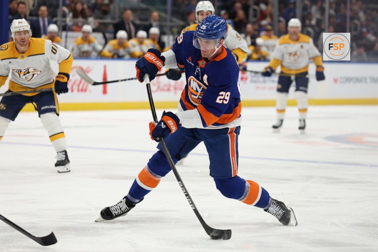 Mar 1, 2025; Elmont, New York, USA; New York Islanders center Brock Nelson (29) take a shot against the Nashville Predators during the second period at UBS Arena. Credit: Thomas Salus-Imagn Images