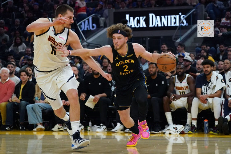 Feb 22, 2026; San Francisco, California, USA;  Golden State Warriors guard Brandin Podziemski (2) drives to the basket against Denver Nuggets center Nikola Jokic (15) in the second quarter at Chase Center. Credit: David Gonzales-Imagn Images