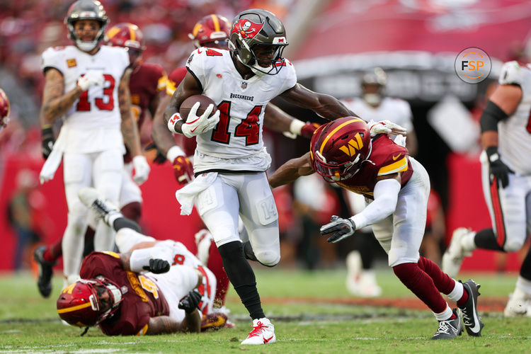 Sep 8, 2024; Tampa, Florida, USA; Tampa Bay Buccaneers wide receiver Chris Godwin (14) runs with the ball against the Washington Commanders in the fourth quarter at Raymond James Stadium. Credit: Nathan Ray Seebeck-Imagn Images