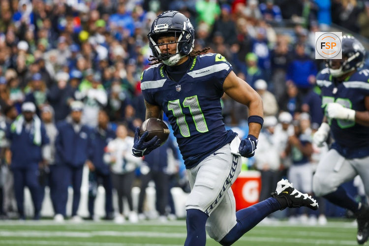 Nov 24, 2024; Seattle, Washington, USA; Seattle Seahawks wide receiver Jaxon Smith-Njigba (11) runs for yards after the catch against the Arizona Cardinals during the second quarter at Lumen Field. Credit: Joe Nicholson-Imagn Images