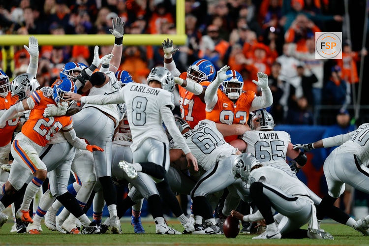 Nov 6, 2025; Denver, Colorado, USA; Las Vegas Raiders place kicker Daniel Carlson (8) misses a field goal as Denver Broncos defensive tackle D.J. Jones (93) and wide receiver A.T. Perry (87) defend in the fourth quarter at Empower Field at Mile High. Credit: Isaiah J. Downing-Imagn Images