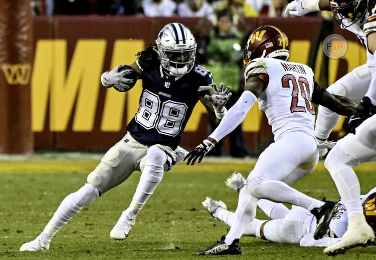 LANDOVER, MD - JANUARY 07: Dallas Cowboys wide receiver CeeDee Lamb (88) makes a reception against Washington Commanders defensive back Quan Martin (20) during the NFL game between the Dallas Cowboys and the Washington Commanders on January 7, 2024 at Fed Ex Field in Landover, MD. (Photo by Mark Goldman/Icon Sportswire)