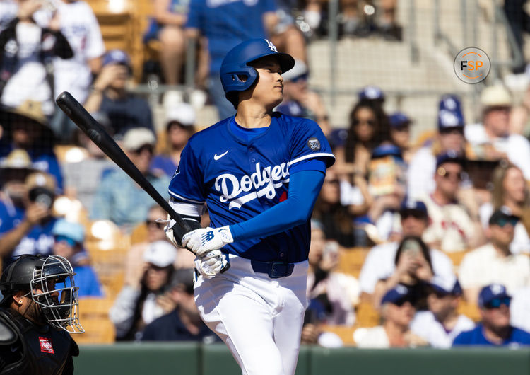 Mar 2, 2025; Phoenix, Arizona, USA; Los Angeles Dodgers designated hitter Shohei Ohtani (17) hits a single against the Chicago White Sox during a spring training game at Camelback Ranch-Glendale. Credit: Mark J. Rebilas-Imagn Images