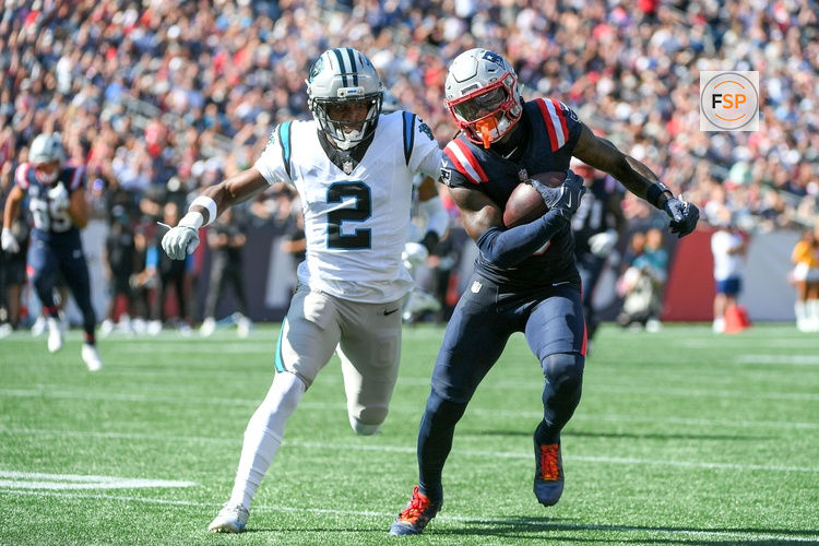 Sep 28, 2025; Foxborough, Massachusetts, USA; New England Patriots wide receiver Stefon Diggs (8) runs the ball while Carolina Panthers cornerback Mike Jackson (2) defends during the first half at Gillette Stadium. Credit: Bob DeChiara-Imagn Images