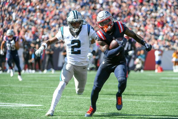 Sep 28, 2025; Foxborough, Massachusetts, USA; New England Patriots wide receiver Stefon Diggs (8) runs the ball while Carolina Panthers cornerback Mike Jackson (2) defends during the first half at Gillette Stadium. Mandatory Credit: Bob DeChiara-Imagn Images