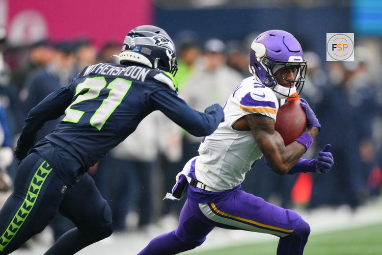 Dec 22, 2024; Seattle, Washington, USA; Minnesota Vikings wide receiver Jordan Addison (3) carries the ball after catch while defended by Seattle Seahawks cornerback Devon Witherspoon (21) during the first half at Lumen Field. Credit: Steven Bisig-Imagn Images