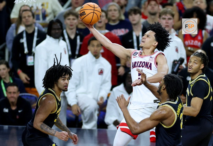 Apr 4, 2026; Indianapolis, IN, USA; Arizona Wildcats guard Brayden Burries (5) goes to the basket against Michigan Wolverines forward Morez Johnson Jr. (21) in the second half during a semifinal of the Final Four of the men's 2026 NCAA Tournament at Lucas Oil Stadium. Credit: Trevor Ruszkowski-Imagn Images