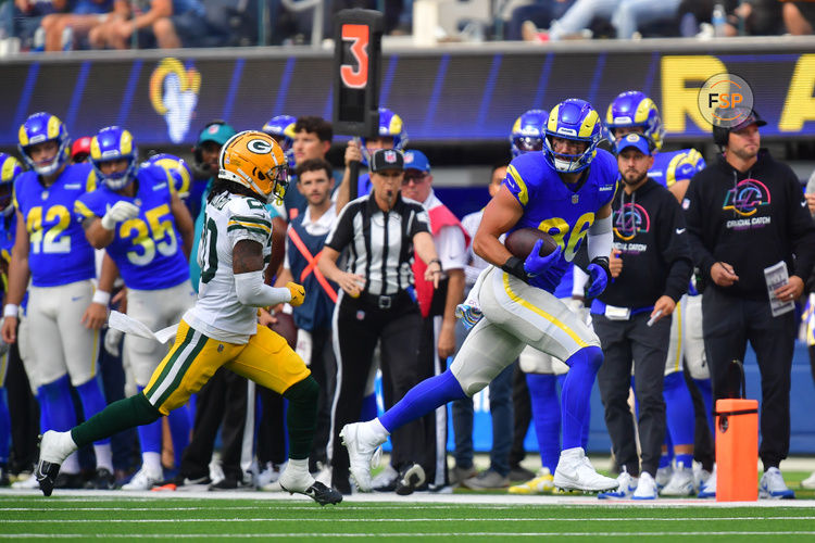 Oct 6, 2024; Inglewood, California, USA; Los Angeles Rams tight end Colby Parkinson (86) runs the ball ahead of Green Bay Packers safety Javon Bullard (20) during the second half at SoFi Stadium. Credit: Gary A. Vasquez-Imagn Images