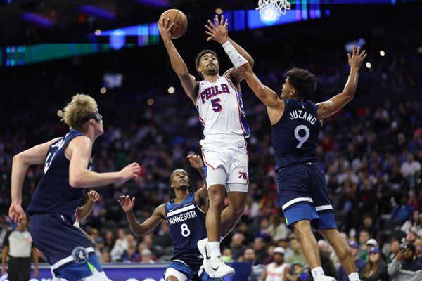 Oct 17, 2025; Philadelphia, Pennsylvania, USA; Philadelphia 76ers guard Quentin Grimes (5) drives for a shot against Minnesota Timberwolves Johnny Juzang (9) during the third quarter at Xfinity Mobile Arena. Mandatory Credit: Bill Streicher-Imagn Images