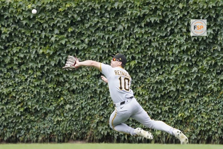 Jun 14, 2025; Chicago, Illinois, USA; Pittsburgh Pirates outfielder Bryan Reynolds (10) makes a catch on Chicago Cubs first base Michael Busch (not pictured) during the seventh inning at Wrigley Field. Credit: David Banks-Imagn Images
