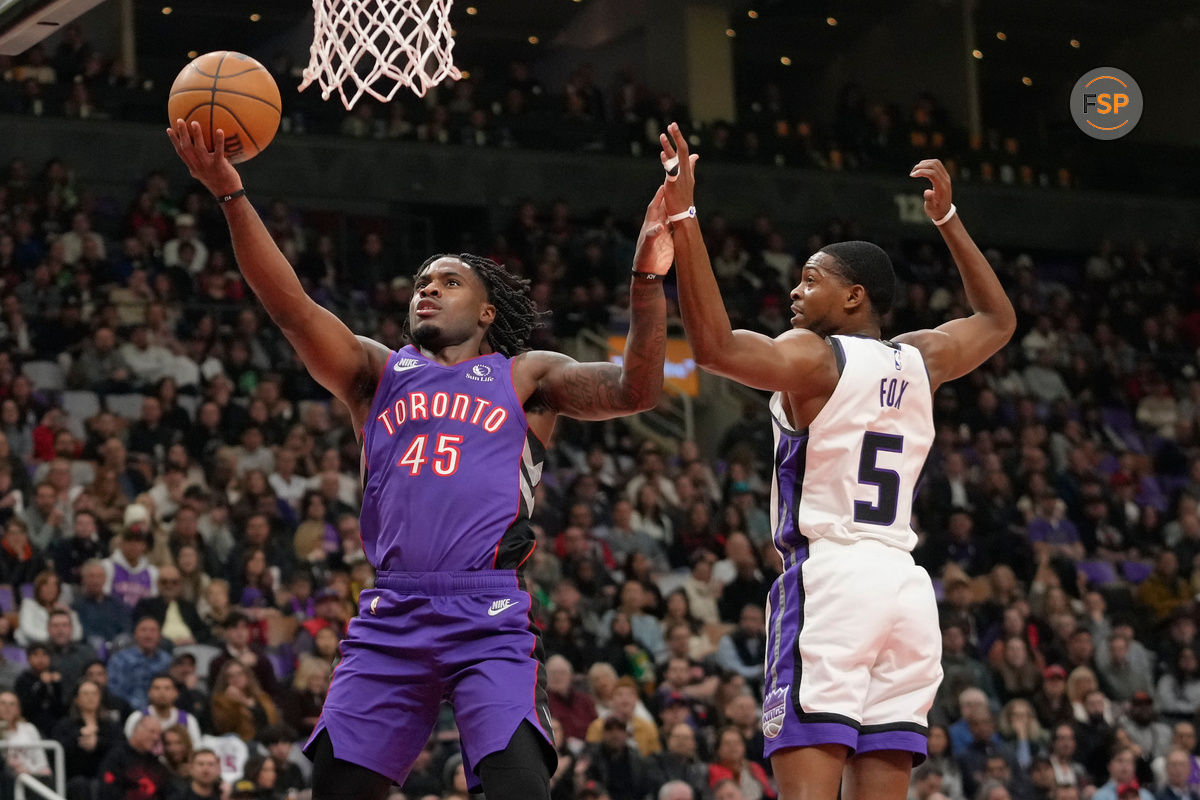 Nov 2, 2024; Toronto, Ontario, CAN; Toronto Raptors guard Davion Mitchell (45) goes up to make a basket against Sacramento Kings guard De'Aaron Fox (5) during the first half at Scotiabank Arena. Credit: John E. Sokolowski-Imagn Images