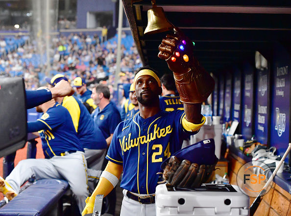 ST PETERSBURG, FLORIDA - JUNE 28: Andrew McCutchen #24 of the Milwaukee Brewers rings a bell while wearing a Thanos Guantlet after hitting a two-run home run in the sixth inning against the Tampa Bay Rays at Tropicana Field on June 28, 2022 in St Petersburg, Florida. (Photo by Julio Aguilar/Getty Images)