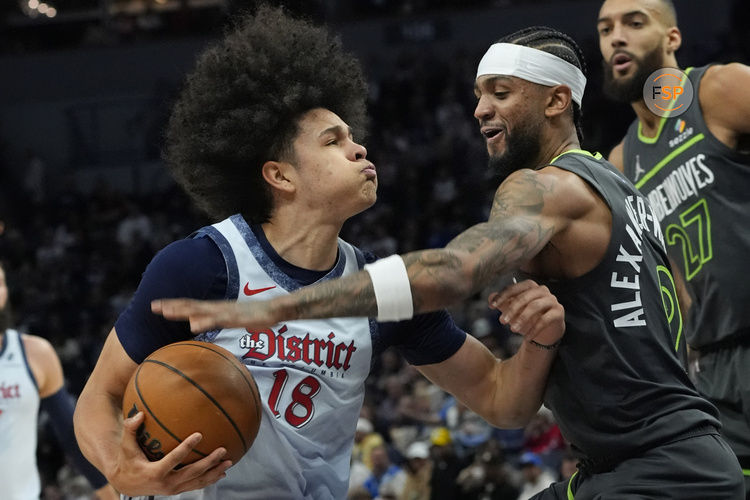 Feb 1, 2025; Minneapolis, Minnesota, USA; Washington Wizards forward Kyshawn George (18) works past Minnesota Timberwolves forward Nickeil Alexander-Walker (9) in the first quarter at Target Center. Credit: Bruce Kluckhohn-Imagn Images