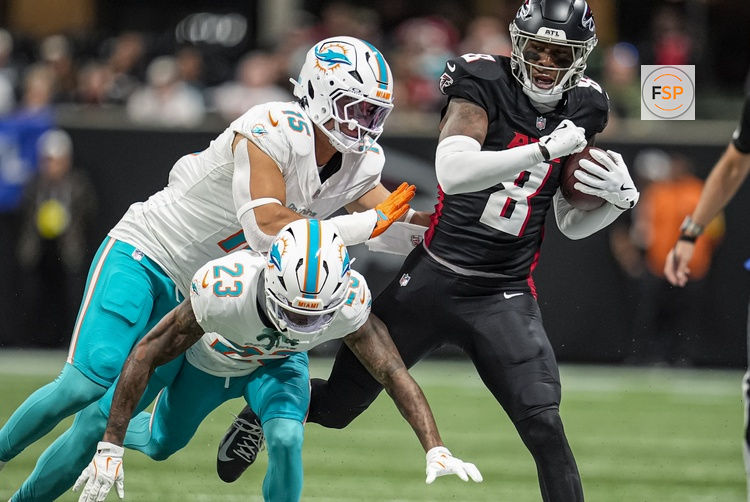 Oct 26, 2025; Atlanta, Georgia, USA; Atlanta Falcons tight end Kyle Pitts Sr. (8) is knocked out of bounds by Miami Dolphins linebacker Jaelan Phillips (15) and cornerback Jack Jones (23) during the first half at Mercedes-Benz Stadium. Credit: Dale Zanine-Imagn Images